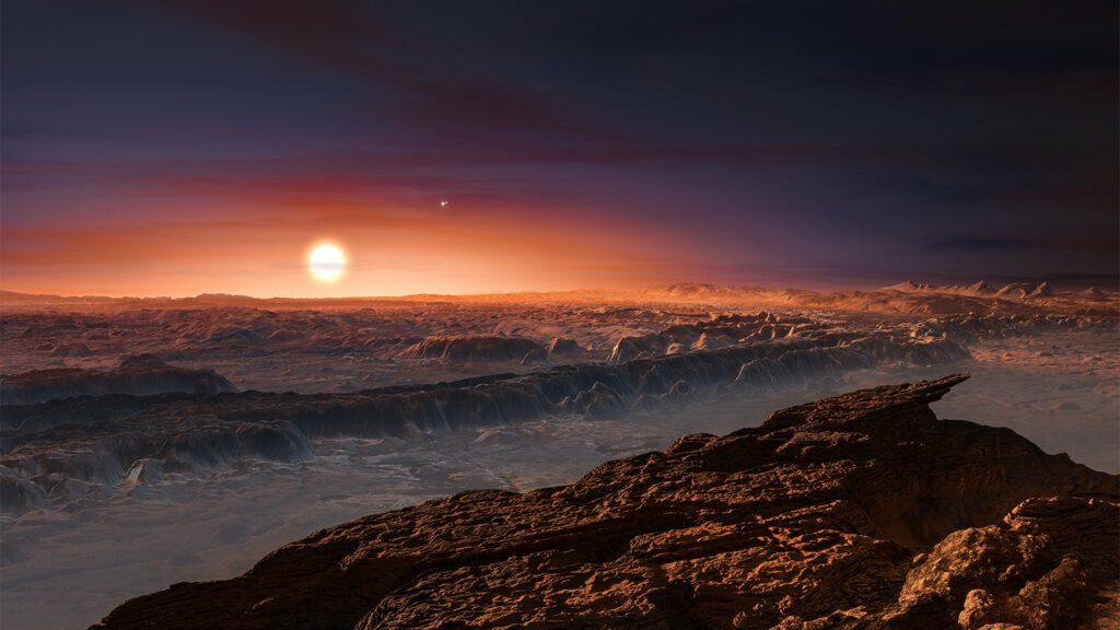 Potenzielles Ziel von Spaceping: Proxima b. Diese künstlerische Darstellung zeigt einen Blick auf die Oberfläche des Exo-Planeten, der den roten Zwergstern Proxima Centauri umkreist, der dem Sonnensystem am nächsten ist. Der Doppelstern Alpha Centauri AB erscheint ebenfalls im Bild oben rechts von Proxima selbst. Proxima b ist etwas massereicher als die Erde und kreist in der bewohnbaren Zone um Proxima Centauri, wo die Temperatur für die Existenz von flüssigem Wasser auf seiner Oberfläche geeignet ist.
